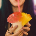 Photo of woman with cocktail umbrella