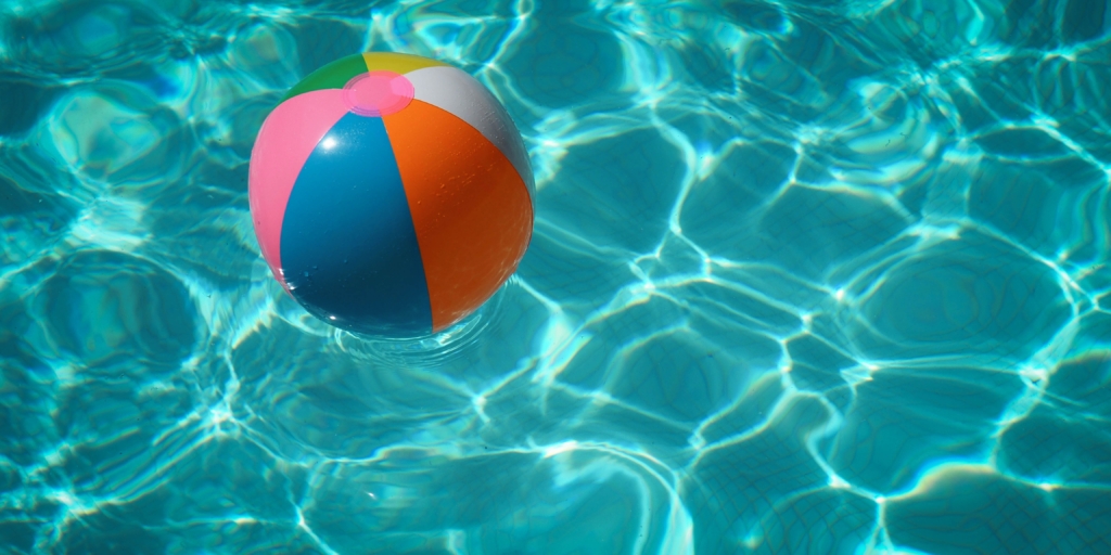 Beach ball in clear, blue water